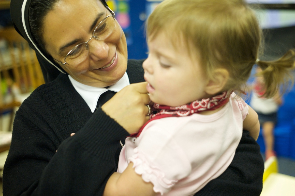 Nun holding a child